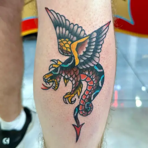 Flying snake tattoo in American traditional style by Dustin Gormley, Waikiki Hawaii