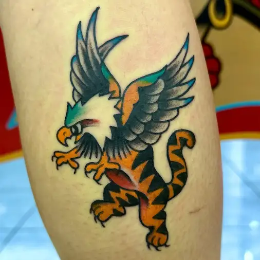 Bold traditional griffin tattoo with tiger body by Dustin Gormley in Waikiki Hawaii