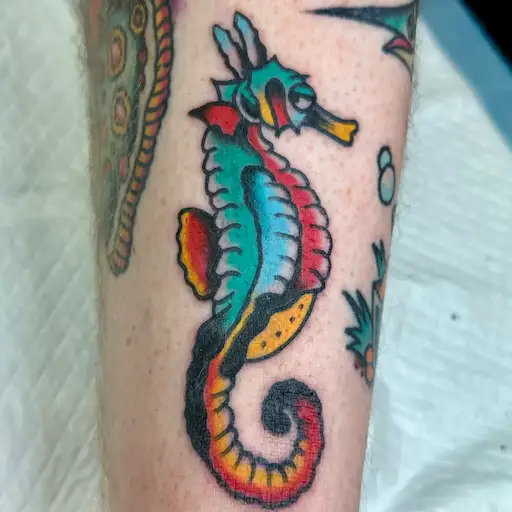 Colorful seahorse tattoo in traditional style by Waikiki tattoo artist Dustin Gormley