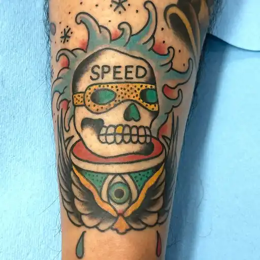 Traditional skull tattoo with flames and SPEED goggles by Dustin Gormley in Waikiki Hawaii